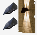 Buitenstee Luna — solar wandlamp met sterpatroon lichteffect op buitenmuur (tijdelijke leveranciersfoto, ter preview)